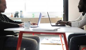 two men sitting at their desk