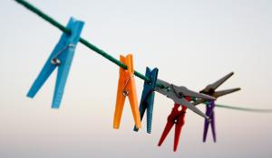 Image: clothespins on a line. Title: Going Green: Eco-Friendly Laundry Products