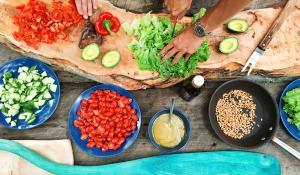 Image: hands chopping colorful vegetables. Topic: Green Living: 10 Habits of Highly Sustainable People