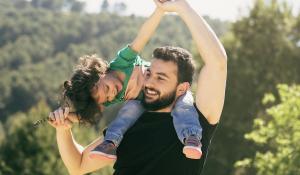 father lifting his daughter playfully