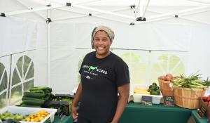 Liz Abunaw poses in her market in a tent