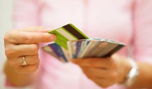 Image: person holding multiple credit cards. Topic: Find A Socially Responsible Credit Card