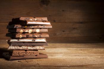 Image: stack of chocolate bars. Topic: Child Labor in Your Chocolate? Check Our Chocolate Scorecard