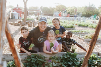 Image: Kim and students at the school farm. Title: Inspiring Future Climate Victory Gardeners at Moss Haven Elementary