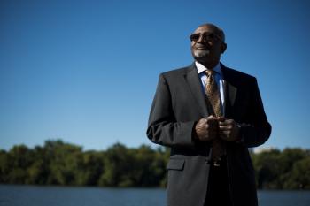 Image: Robert Bullard, black man standing in suit with blue sky in background. Topic: 8 Black Leaders Who've Revolutionized the Climate Movement