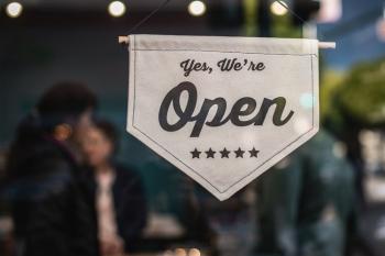 hanging open sign on glass window 