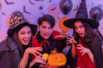 Three young Asian people dressed up for Halloween at a party. Sustainable Halloween Costumes.