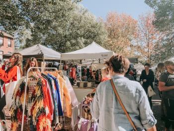 People shopping at a local, outdoor market. Ethical shopping resolutions.