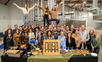 workers at Pacha factory standing together and smiling at the camera in celebration of achieving the Soil Climate Health Intiative label.