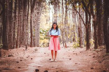 woman walking in trees